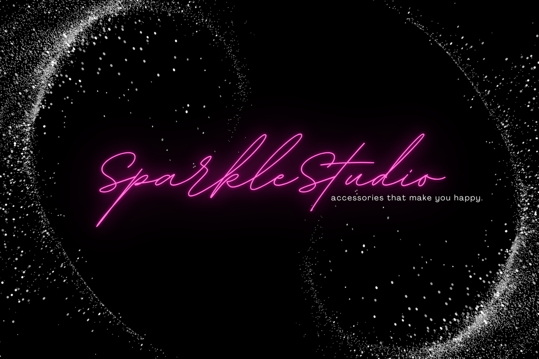 Sparkle Studio logo in pink on a black background with star-like dots