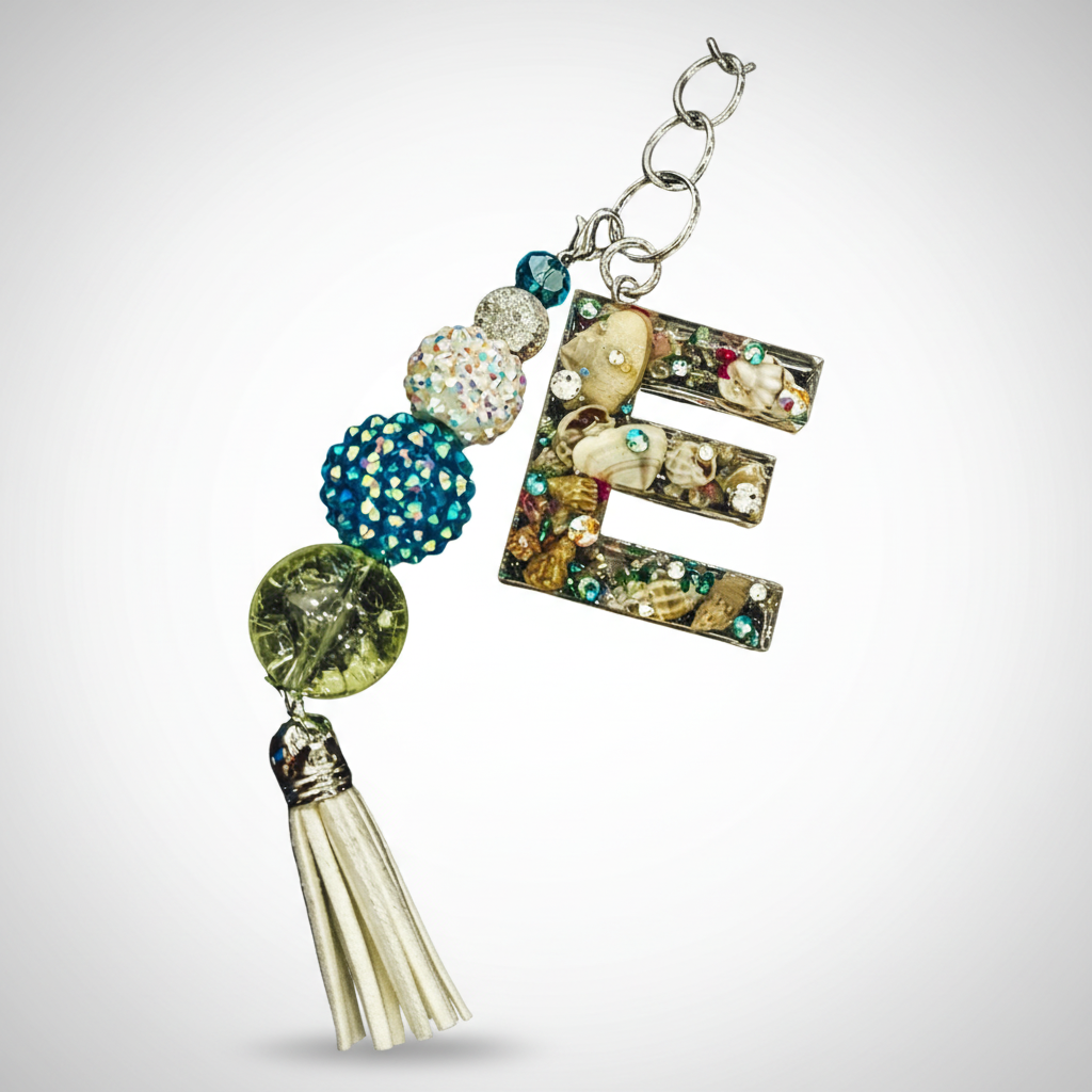 Custom resin keychains and purse charms displayed on a pastel background